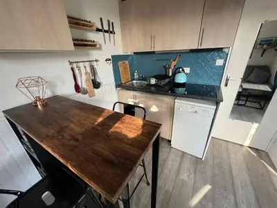a kitchen with a wooden counter top in a room at Samoens centre - appartement une chambre in Samoëns