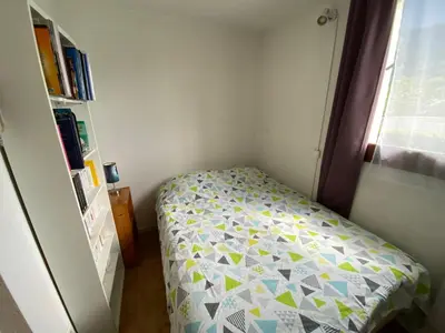 a small bedroom with a bed and a window at Samoens centre - appartement une chambre in Samoëns