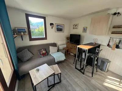 a living room with a couch and a table at Samoens centre - appartement une chambre in Samoëns