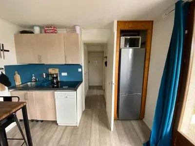 a kitchen with a stainless steel refrigerator in a room at Samoens centre - appartement une chambre in Samoëns