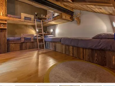 a room with two bunk beds and a rug at Très bel appartement Duplex 9 couchages in Megève
