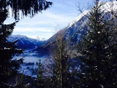 a snow covered mountain with a lake and trees at Large peaceful chalet for mountain adventures! Perfect for Flégère and Grand Montet skiing in Chamonix-Mont-Blanc