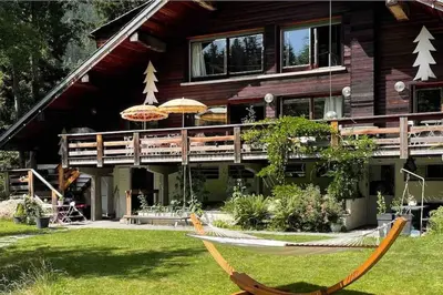 a house with a hammock in front of it at Large peaceful chalet for mountain adventures! Perfect for Flégère and Grand Montet skiing in Chamonix-Mont-Blanc