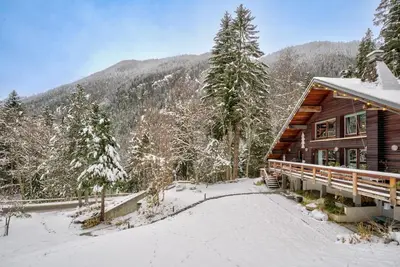 a log cabin in the snow next to a mountain at Large peaceful chalet for mountain adventures! Perfect for Flégère and Grand Montet skiing in Chamonix-Mont-Blanc