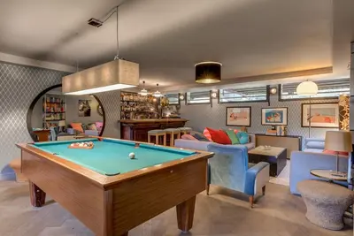 a living room with a pool table at Large peaceful chalet for mountain adventures! Perfect for Flégère and Grand Montet skiing in Chamonix-Mont-Blanc