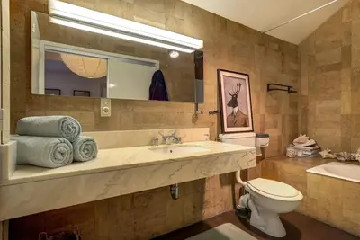 a bathroom with a sink and a toilet and a mirror at Large peaceful chalet for mountain adventures! Perfect for Flégère and Grand Montet skiing in Chamonix-Mont-Blanc