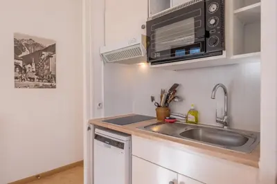 a kitchen with a sink and a microwave at Charming flat right in the city centre in Chamonix-Mont-Blanc