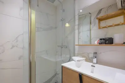 a bathroom with a shower and a sink at Charming flat right in the city centre in Chamonix-Mont-Blanc