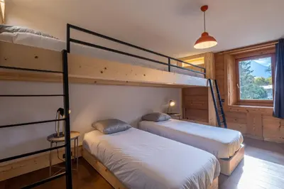 a bedroom with two bunk beds and a window at SmartStay Loft - Exterieur et vue Mont Blanc in Chamonix-Mont-Blanc