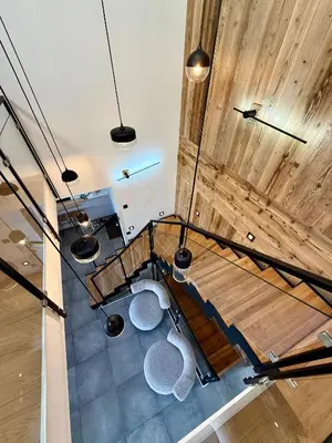 an overhead view of a room with wooden ceilings and benches at Chalet Petit Val in Combloux