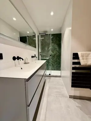 a bathroom with two sinks and a shower at Chalet Petit Val in Combloux