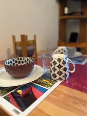 a table with a bowl and a cup on it at Emeraude, petit cocon proche des pistes in Saint-Gervais-les-Bains