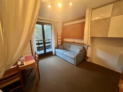 a living room with a couch and a window at Emeraude, petit cocon proche des pistes in Saint-Gervais-les-Bains