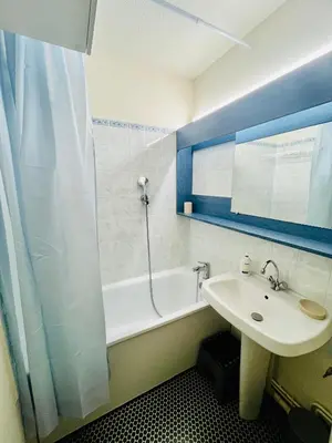 a bathroom with a sink and a bath tub at Emeraude, petit cocon proche des pistes in Saint-Gervais-les-Bains