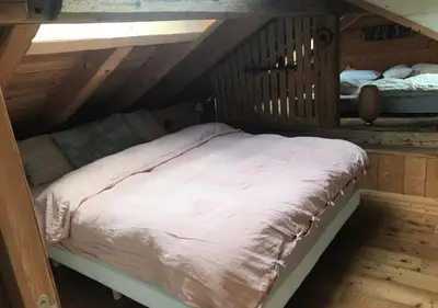 a bed in a wooden room with at Hameau de la Côte in Les Houches