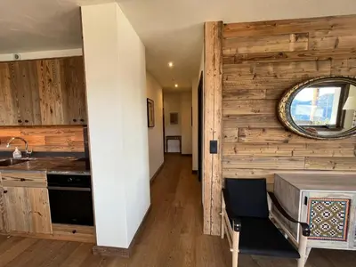 a kitchen with a sink and a mirror on a wall at La Belle Etoile in Saint-Gervais-les-Bains
