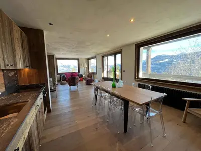 a living room with a table and a large window at La Belle Etoile in Saint-Gervais-les-Bains