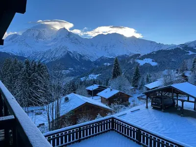 a view of a snowy mountain range from a balcony at La Belle Etoile in Saint-Gervais-les-Bains