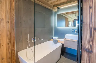 a bathroom with a bath tub and a sink at Appartement Horizon Panoramique - Welkeys in Combloux