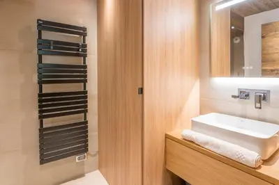 a bathroom with a sink and a mirror at Appartement Horizon Panoramique - Welkeys in Combloux