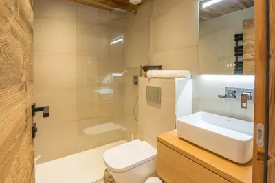 a bathroom with a white toilet and a sink at Appartement Horizon Panoramique - Welkeys in Combloux