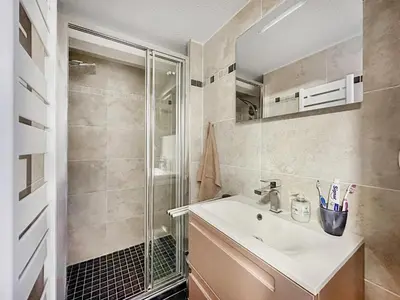 a bedroom with a bed in a room at bar08 2 pieces mezzanine 6 pers in Les Carroz d'Araches