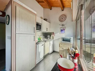 a kitchen with a counter with a red appliance on it at bar08 2 pieces mezzanine 6 pers in Les Carroz d'Araches