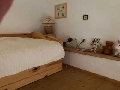 a bedroom with a bed and teddy bears on a shelf at Appartement Balcon piscine tennis vue Montagne in Saint-Gervais-les-Bains