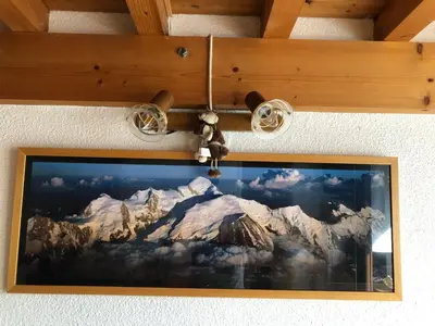 a picture of a mountain painting hanging on a wall at Appartement Balcon piscine tennis vue Montagne in Saint-Gervais-les-Bains