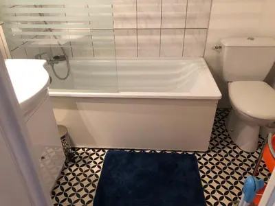 a bathroom with a white tub and a toilet at Appartement Balcon piscine tennis vue Montagne in Saint-Gervais-les-Bains