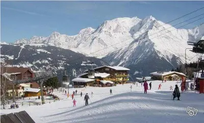 a group of people skiing on a snow covered mountain at Appartement Balcon piscine tennis vue Montagne in Saint-Gervais-les-Bains