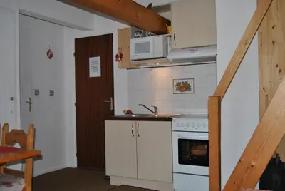 a small kitchen with a sink and a stove at Appartement Balcon piscine tennis vue Montagne in Saint-Gervais-les-Bains