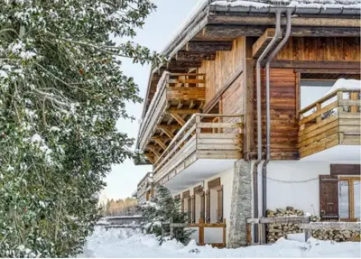 a log house in the snow with stairs at Le Chalet 138 Megève séjour pour 8 confort espace charme calme in Demi-Quartier