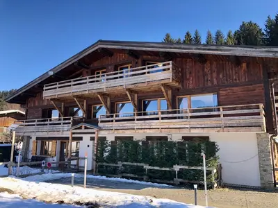a large wooden house with a large balcony at Le Chalet 138 Megève séjour pour 8 confort espace charme calme in Demi-Quartier