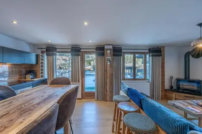 a kitchen with a large wooden table and chairs at Le Chalet 138 Megève séjour pour 8 confort espace charme calme in Demi-Quartier