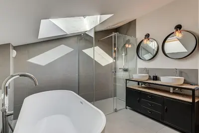 a bathroom with a shower and a sink and mirror at Chalet Arve - Alpes Travel - Chamonix - Sleeps 10 in Chamonix-Mont-Blanc