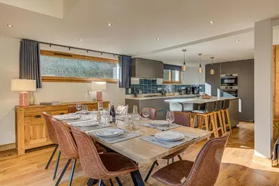 a dining room with a table and chairs in a kitchen at Chalet Arve - Alpes Travel - Chamonix - Sleeps 10 in Chamonix-Mont-Blanc