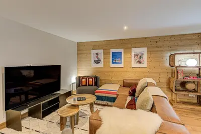 a living room with a couch and a tv at Chalet Arve - Alpes Travel - Chamonix - Sleeps 10 in Chamonix-Mont-Blanc