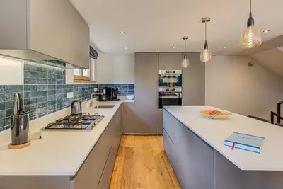 a kitchen with white counters and a counter top at Chalet Arve - Alpes Travel - Chamonix - Sleeps 10 in Chamonix-Mont-Blanc