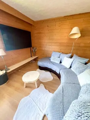 a room with two beds and a flat screen tv at Charmant appartements Sallanches in Sallanches