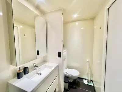 a white bathroom with a sink and a toilet at Charmant appartements Sallanches in Sallanches