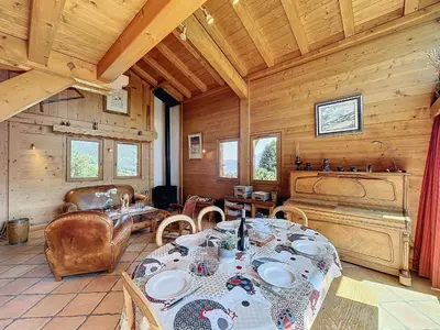 a dining room with a table and chairs in a cabin at Chalet individuel avec garage, terrasse, buanderie et cuisine équipée - FR-1-560-149 in Sallanches