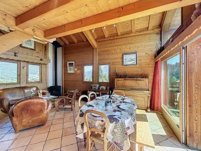 a dining room with a table and chairs at Chalet individuel avec garage, terrasse, buanderie et cuisine équipée - FR-1-560-149 in Sallanches