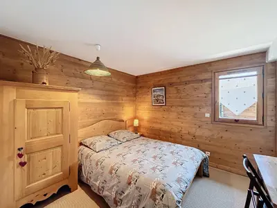 a bedroom with a bed and a window and a table at Chalet individuel avec garage, terrasse, buanderie et cuisine équipée - FR-1-560-149 in Sallanches