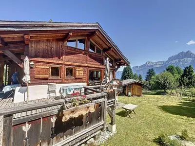 a log cabin with a fence in front of it at Chalet individuel avec garage, terrasse, buanderie et cuisine équipée - FR-1-560-149 in Sallanches