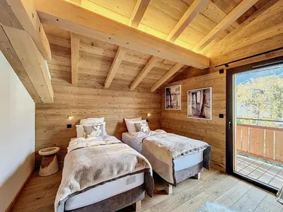 two beds in a room with wooden walls at Chalet de luxe avec vue Mont Blanc et parking - FR-1-560-150 in Sallanches