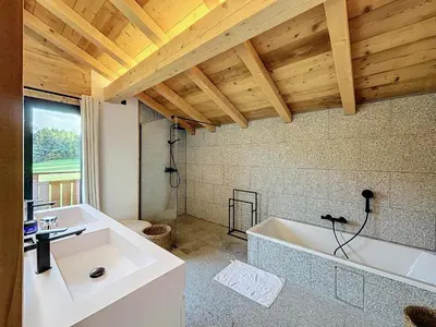 a bathroom with a white tub and a sink at Chalet de luxe avec vue Mont Blanc et parking - FR-1-560-150 in Sallanches