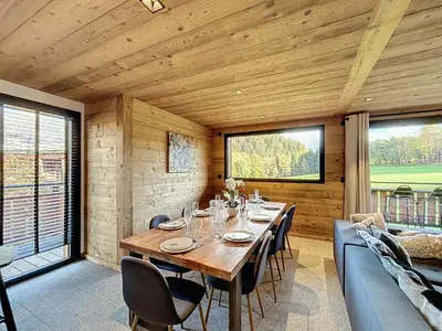 a wooden dining room with a table and chairs at Chalet de luxe avec vue Mont Blanc et parking - FR-1-560-150 in Sallanches