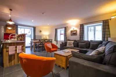 a living room with a couch and a table at Chalet Atelier Chalet Chamonix in Chamonix-Mont-Blanc