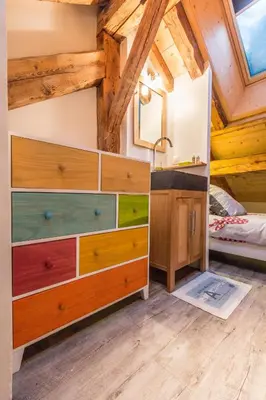 a bedroom with a large dresser and a bed at Chalet Atelier Chalet Chamonix in Chamonix-Mont-Blanc